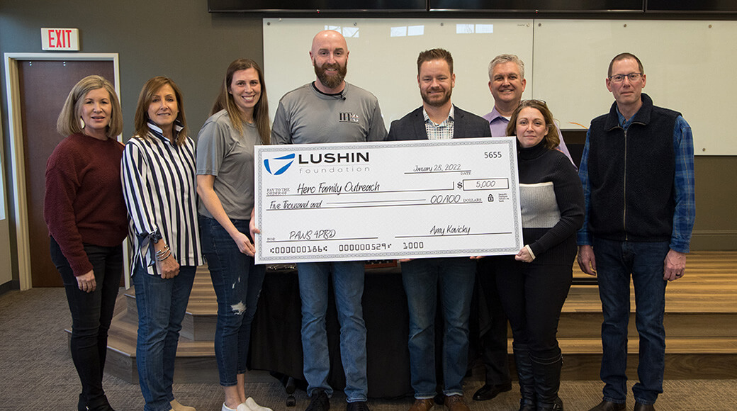 Group photo holding check from Lushin to HFO